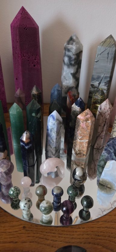A variety of polished crystals and gemstones in various shapes and sizes arranged decoratively.